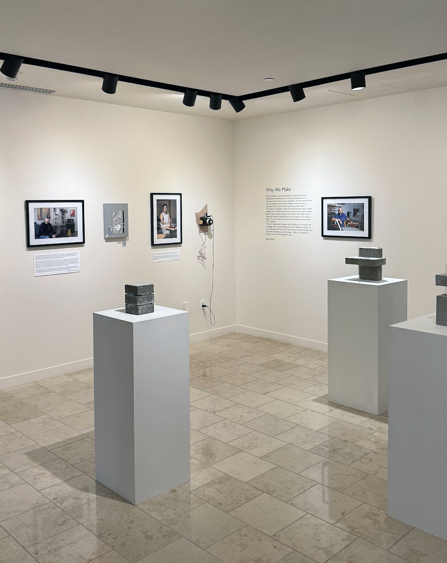 Art gallery displaying the "Why We Make" exhibition with framed artworks and sculptures on pedestals.